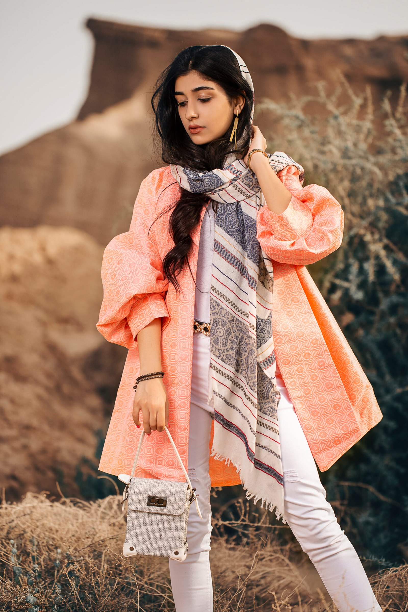 Home fashion model in coral jacket and black shawl
